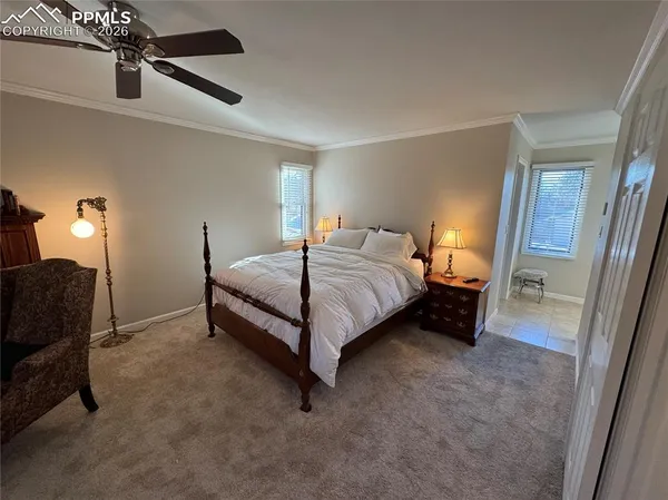 a bedroom with a bed chair and a window