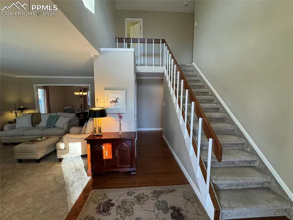 a kitchen with stainless steel appliances granite countertop a sink a stove and a wooden floor