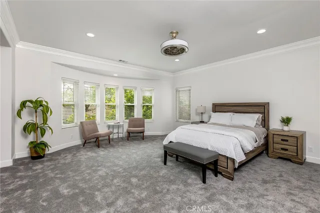 a large white kitchen with a fireplace and a chandelier