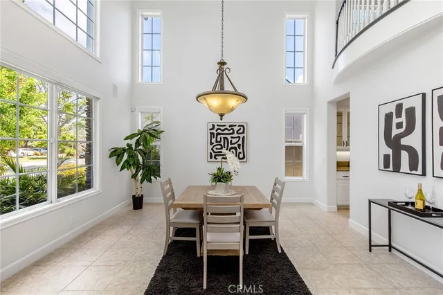 a dining room with furniture a chandelier and window