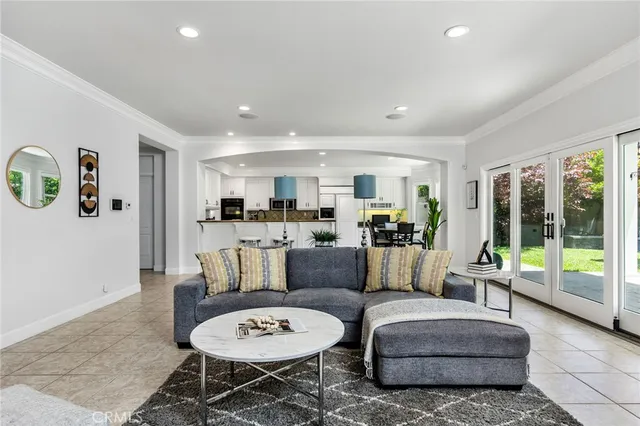 a living room with furniture and a large window with rug view