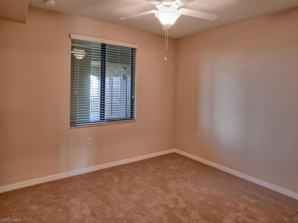 9566 Trevi Court, Unit 4934 Naples, FL 34113 - Photo 11 of 27 an empty room with a window