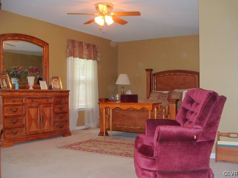 4145 Walter Road Bethlehem, PA 18020 - Photo 7 of 11 a living room with furniture a chandelier and a flat screen tv