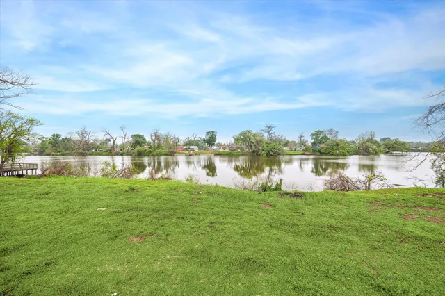 a view of a lake with houses in the background