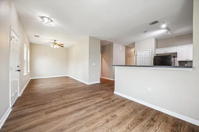 a view of a kitchen with a dishwasher and wooden floor