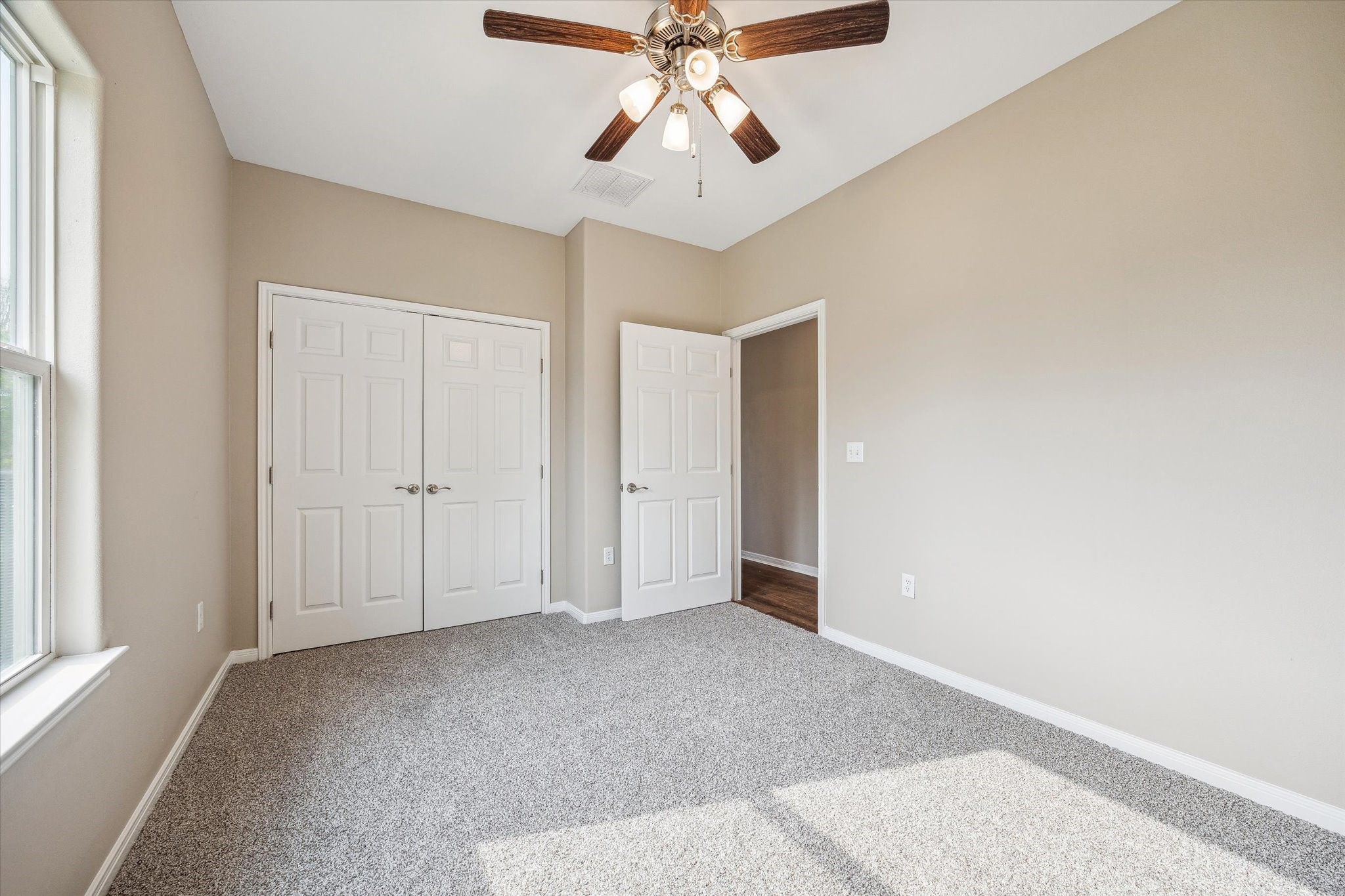 201 Smiley Road Angleton, TX 77515 - Photo 6 of 10 a view of an empty room and chandelier fan