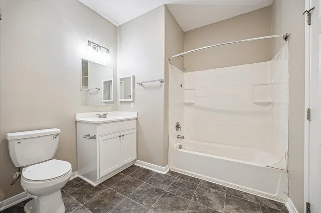 a bathroom with a toilet sink and shower