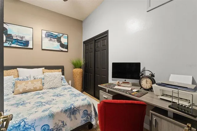 a bedroom with a bed and a desk