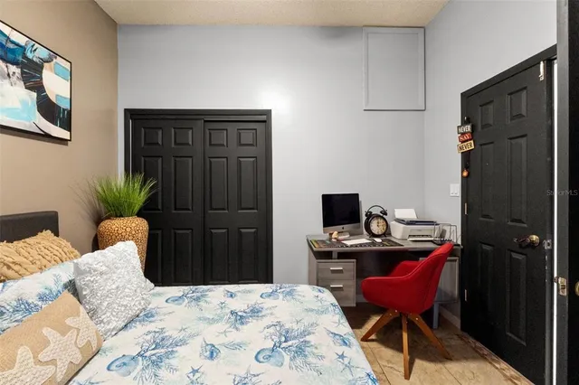 a bedroom with a bed and a desk