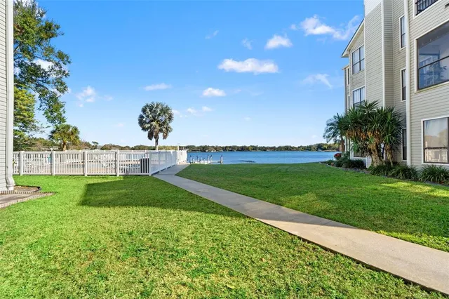 a view of yard with swimming pool and green space