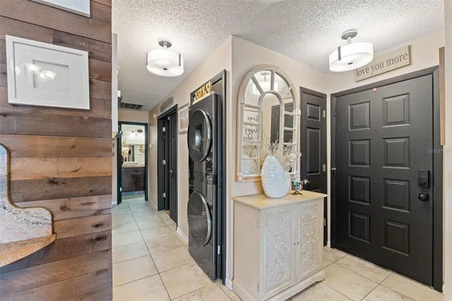 a view of a hallway with wooden floor and a bathroom