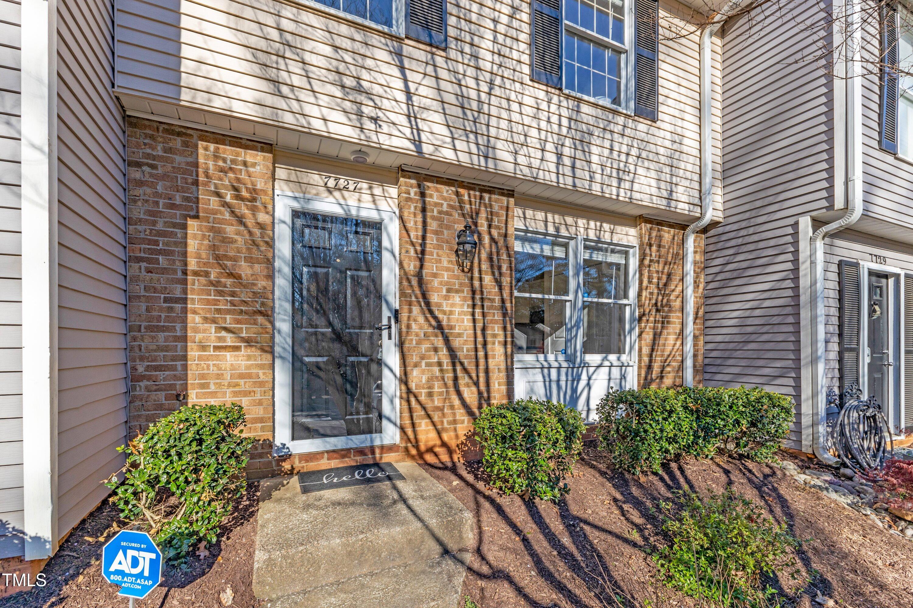 7727 Ohmann Court Raleigh, NC 27615 - Photo 2 of 40 a potted plant sitting in front of a house