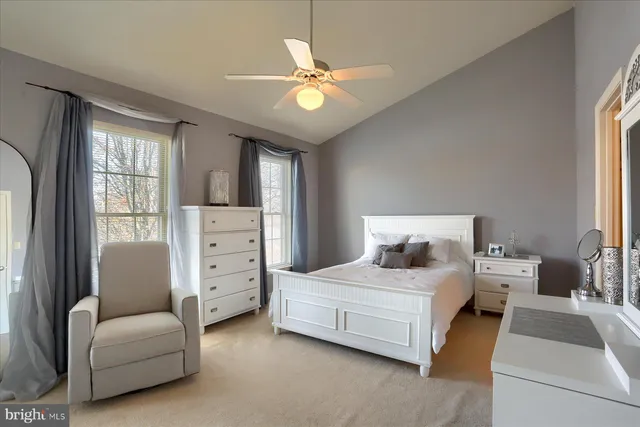 a bedroom with a bed couch and window