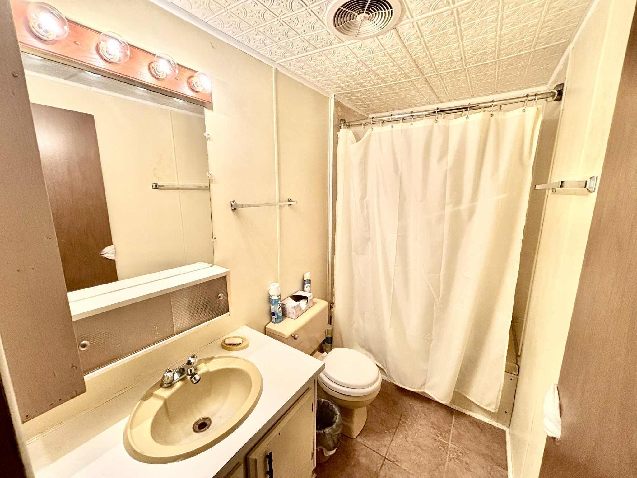 763 West 900 South Hebron, IN 46341 - Photo 12 of 27 a bathroom with a sink a toilet and shower curtain