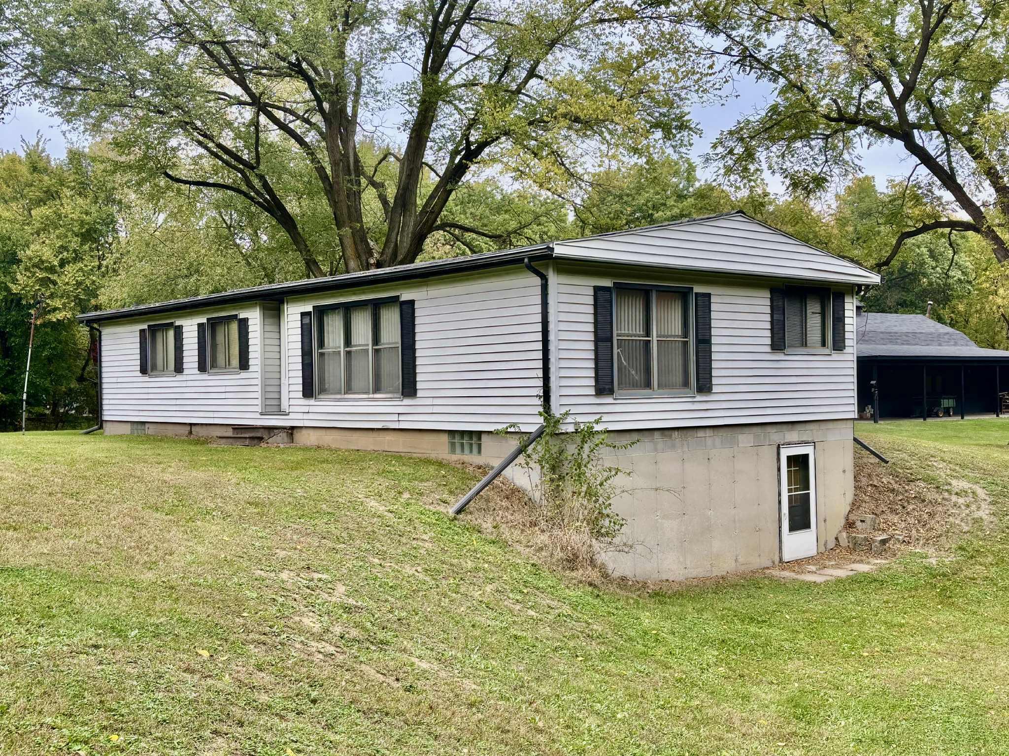 763 West 900 South Hebron, IN 46341 - Photo 2 of 27 a front view of a house with a garden