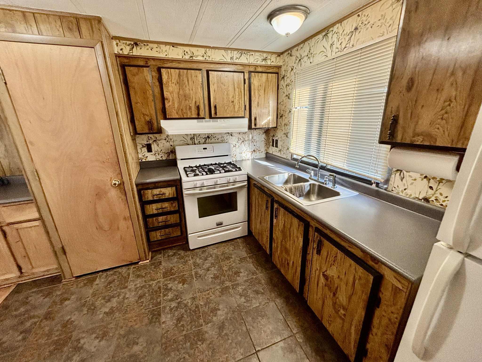 763 West 900 South Hebron, IN 46341 - Photo 7 of 27 a kitchen with a stove a sink and a refrigerator