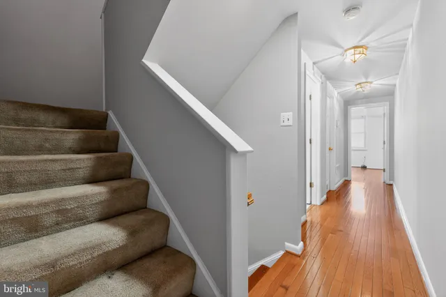 a view of entryway and hall with wooden floor