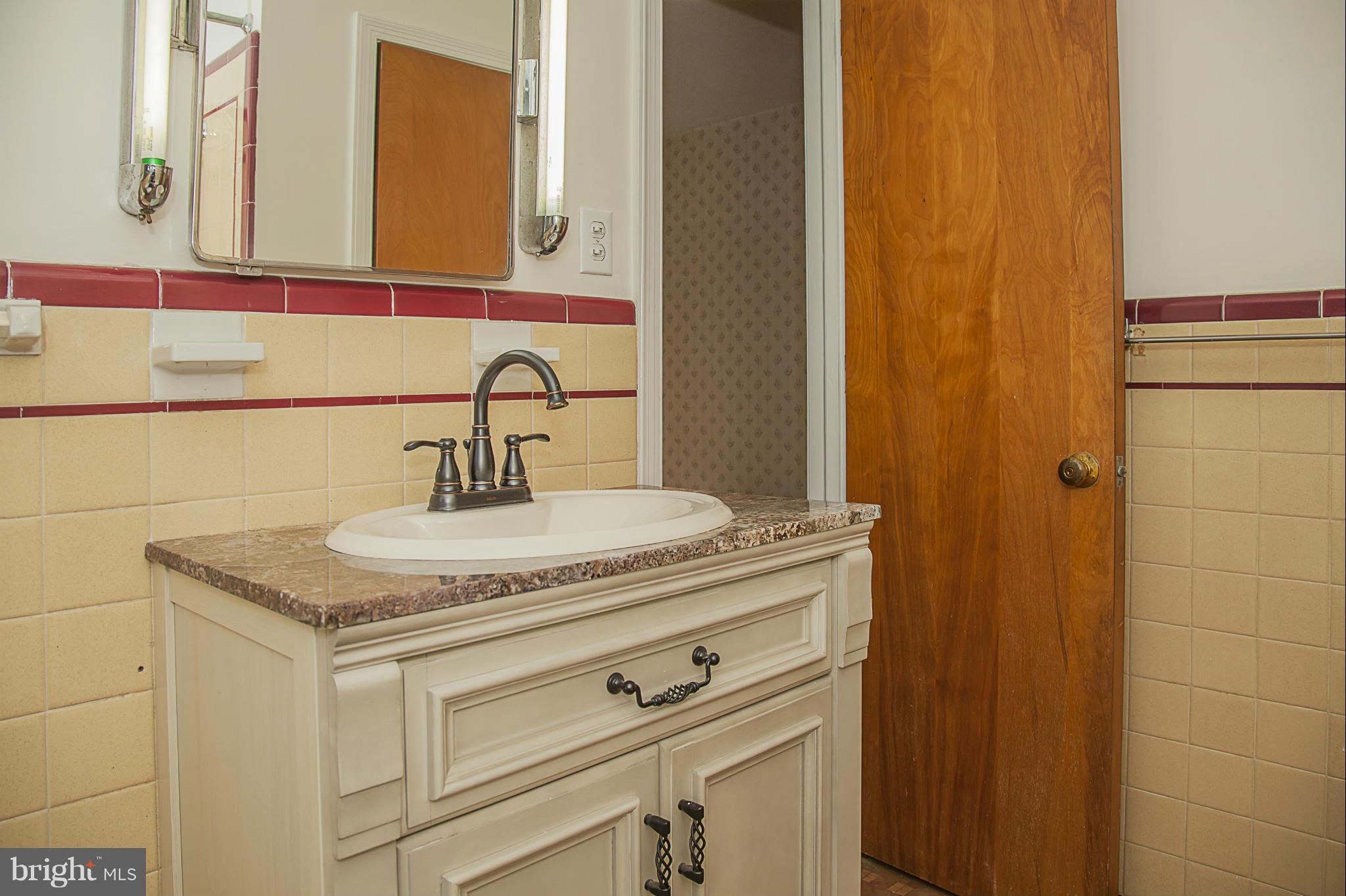 10309 Parkman Road Silver Spring, MD 20903 - Photo 14 of 28 a bathroom with a granite countertop sink and a mirror