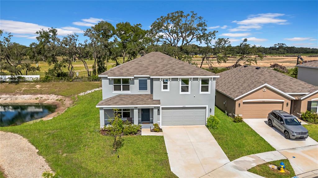 13295 Mylion Way, Unit 1 Spring Hill, FL 34610 - Photo 1 of 59 a front view of a house with a yard