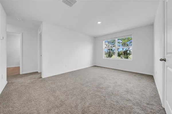 a bedroom with bed and a window