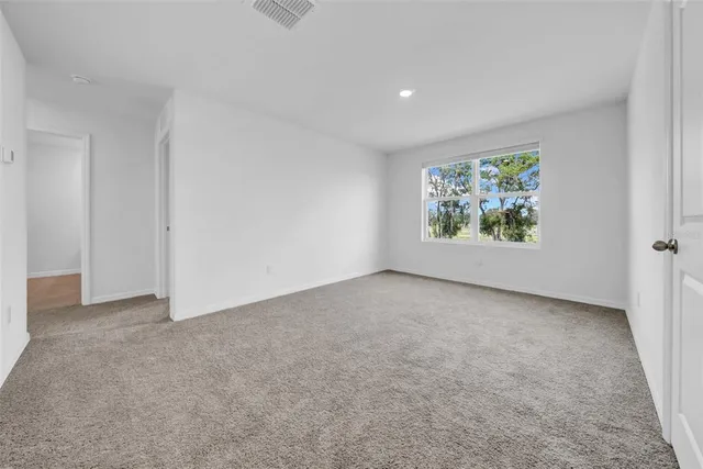 a bedroom with bed and a window