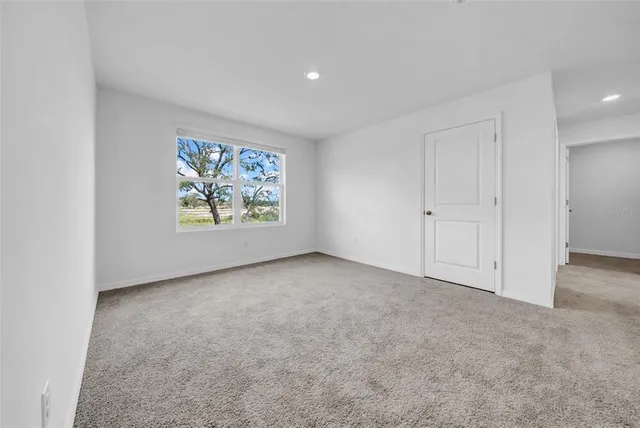 a bedroom with a bed and a lamp