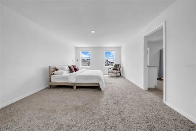 a spacious bedroom with a bed and a couch