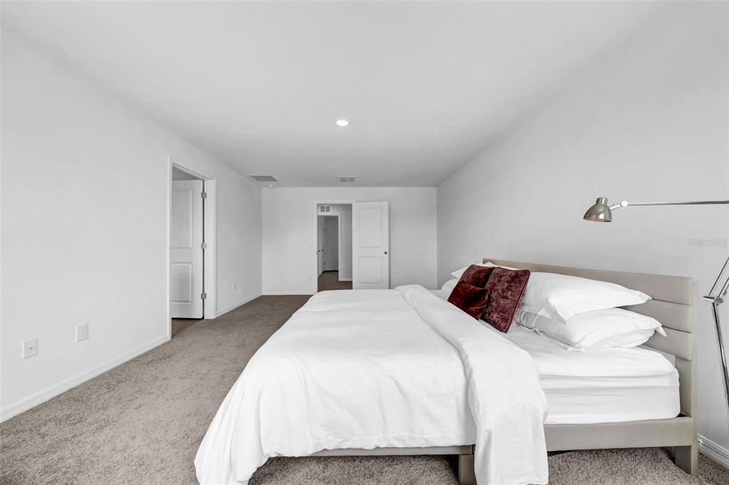 13295 Mylion Way, Unit 1 Spring Hill, FL 34610 - Photo 26 of 59 a bedroom with a bed and a lamp