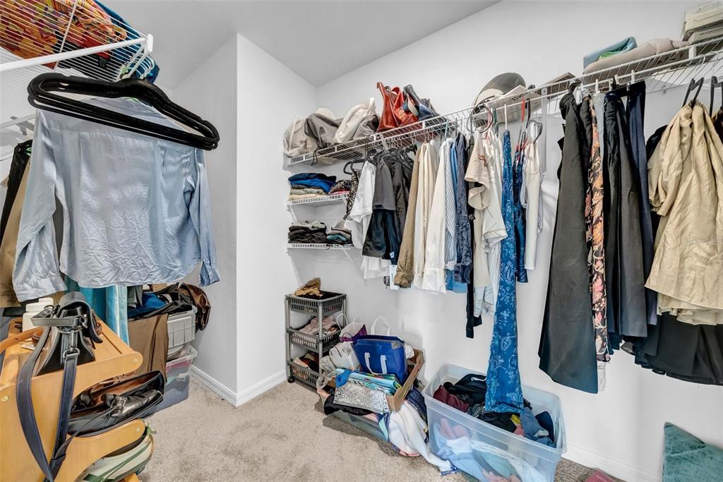 13295 Mylion Way, Unit 1 Spring Hill, FL 34610 - Photo 31 of 59 a view of walk in closet with clothes and shoes