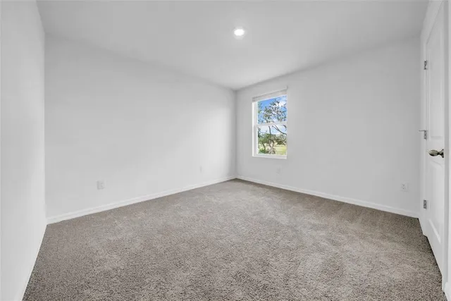 a bedroom with bed and a window