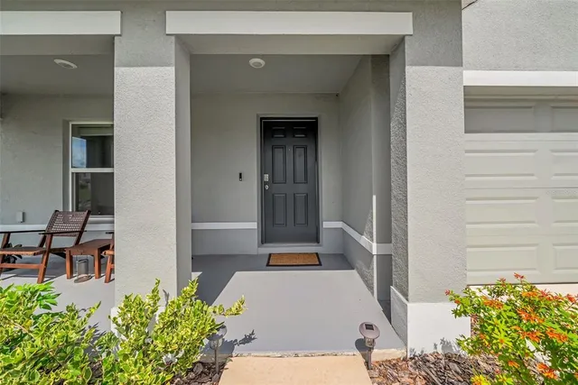 a aerial view of a house with a garden and swimming pool