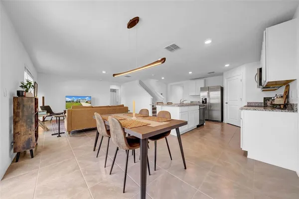 a kitchen with a table and chairs in it