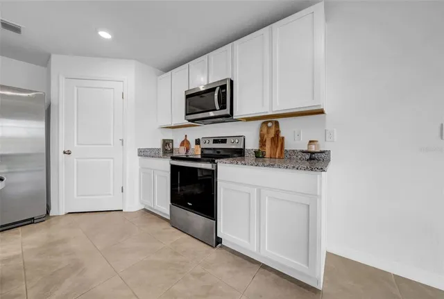 a kitchen with counter top space cabinets and stainless steel appliances