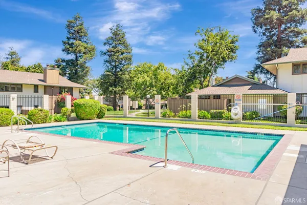 a view of swimming pool with outdoor seating and yard