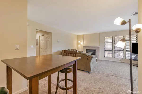 a view of a dining room with furniture and a fireplace