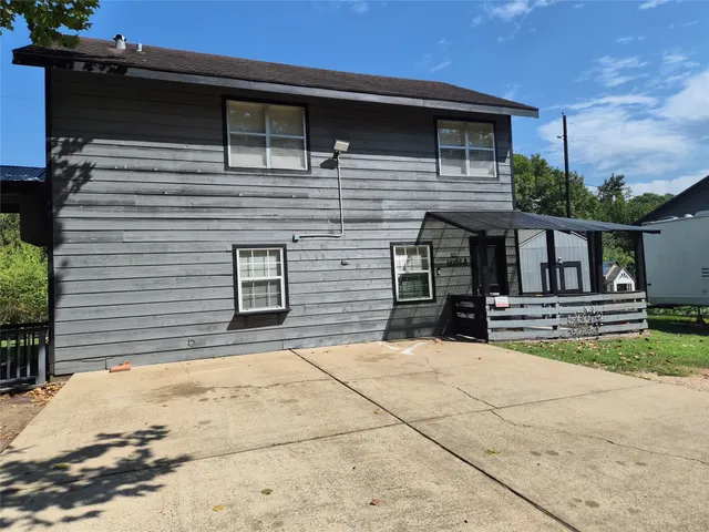 a view of house with outdoor space and parking space