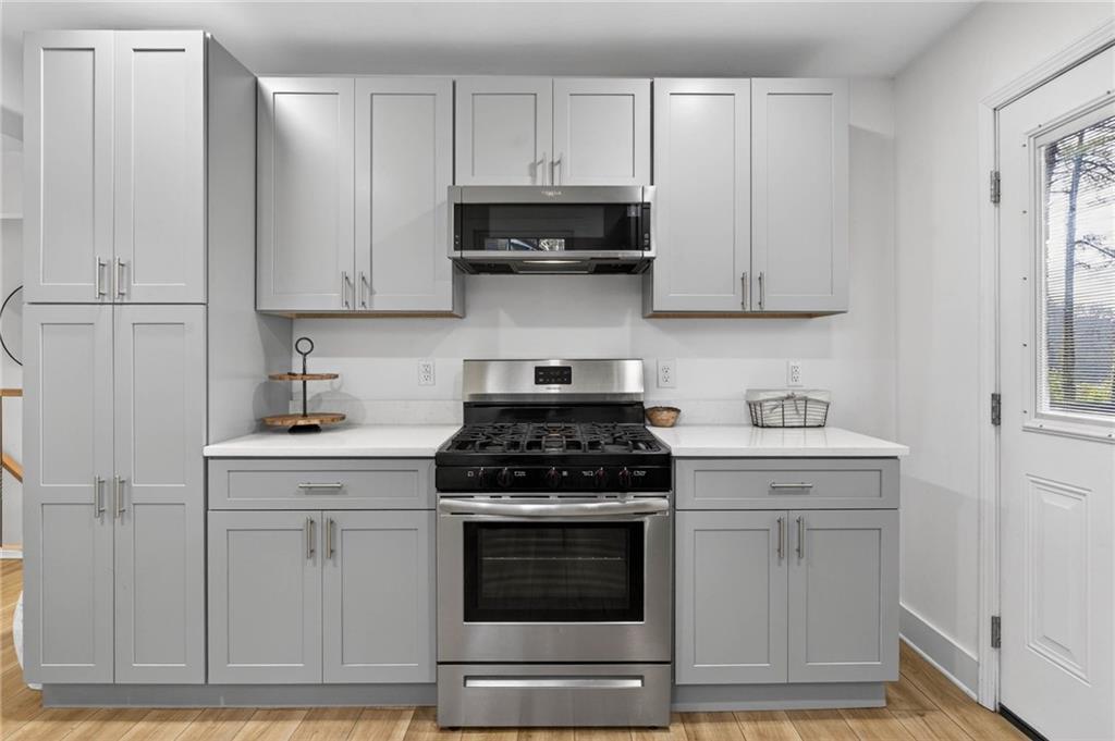 1939 Brannen Road Southeast Atlanta, GA 30316 - Photo 12 of 30 a kitchen with white cabinets and appliances