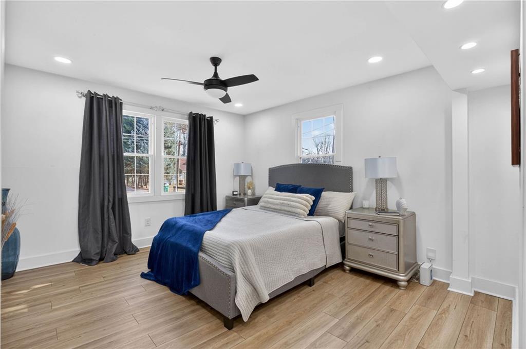 1939 Brannen Road Southeast Atlanta, GA 30316 - Photo 15 of 30 a bedroom with a large bed chandelier and a window