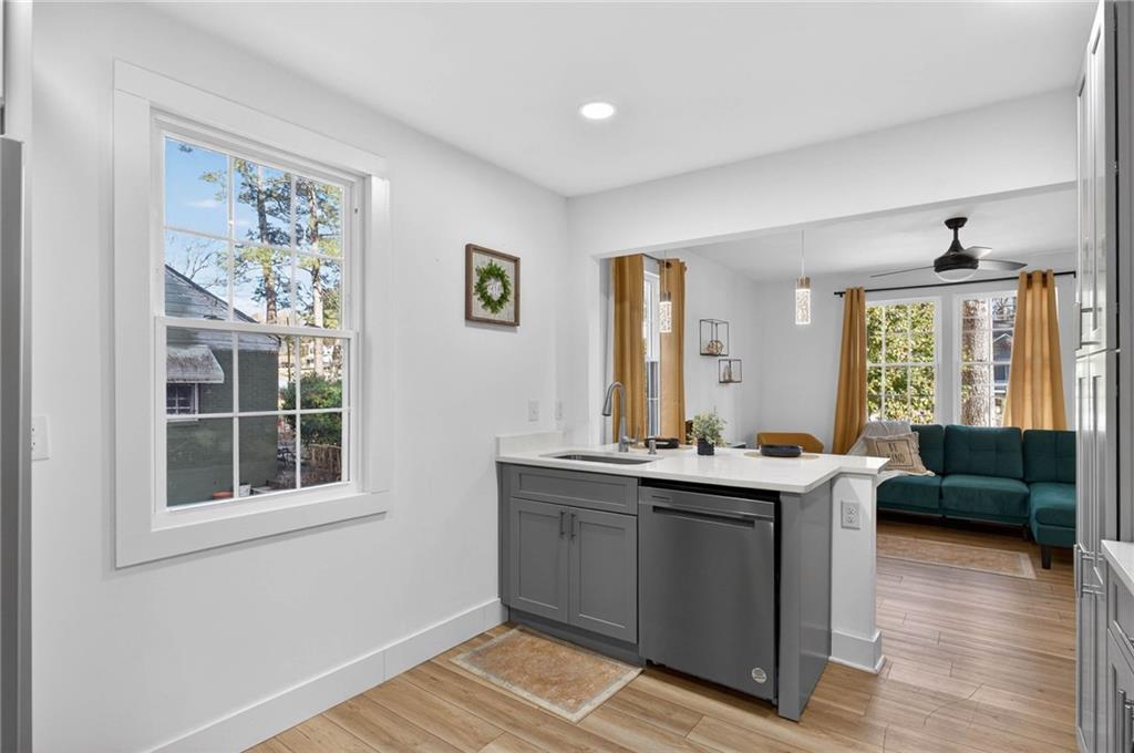 1939 Brannen Road Southeast Atlanta, GA 30316 - Photo 10 of 30 a view of kitchen with stainless steel appliances granite countertop a sink and wooden floor