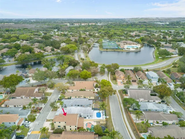 a view of a patio with chair and table and chairs with wooden fence and plants