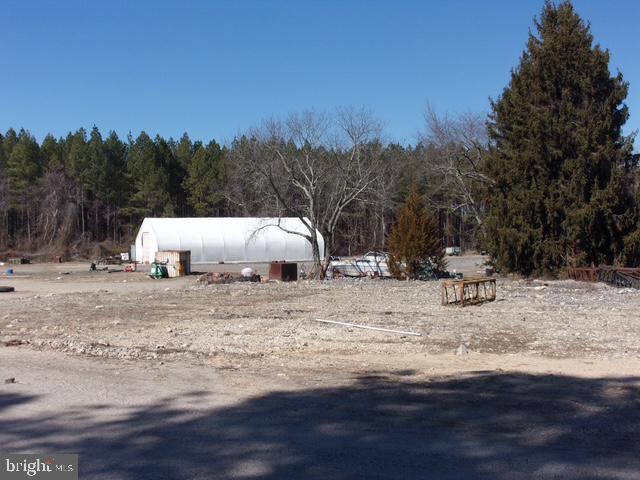 313 Tansboro Road Berlin, NJ 08009 - Photo 2 of 11 a view of a dry yard covered with snow in the background
