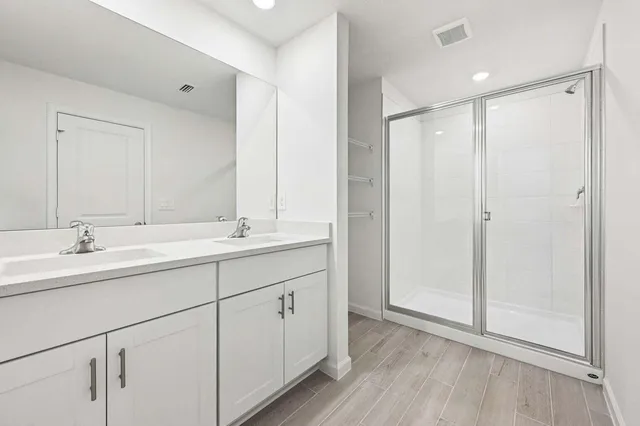 a bathroom with 2 sink and a mirror