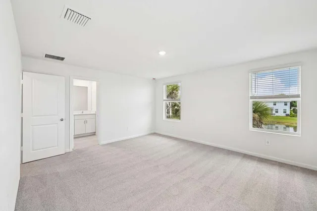 an empty room with windows and closet