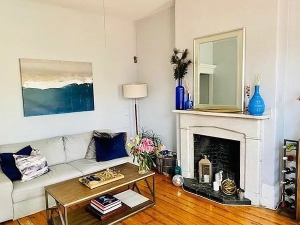 18 Cedar Street, Unit 3 Boston, MA 02129 - Photo 2 of 10 a living room with furniture and a fireplace