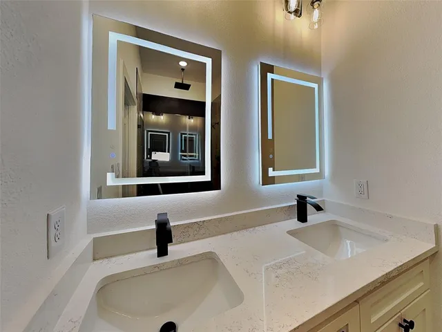 a bathroom with a shower and a sink
