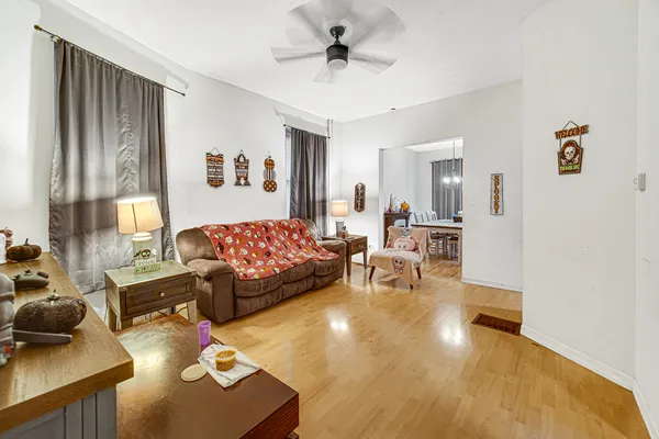 a living room with large furniture and a wooden floor