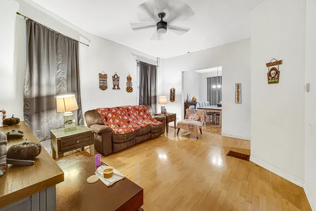 a living room with large furniture and a wooden floor
