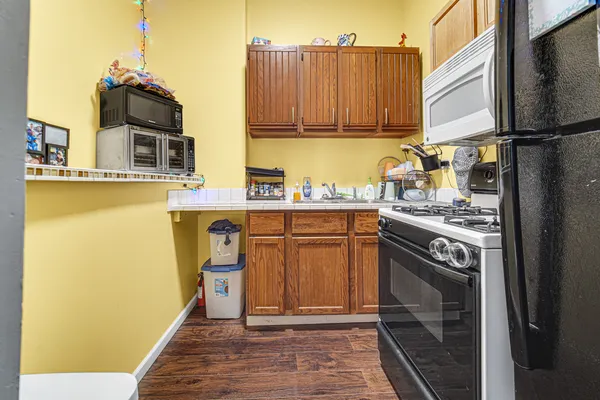 a kitchen with stainless steel appliances granite countertop a stove and a refrigerator