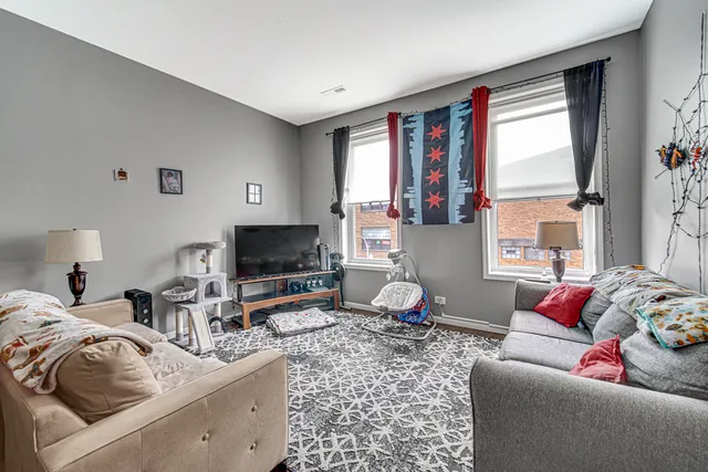 a bedroom with a bed a couch and a chandelier