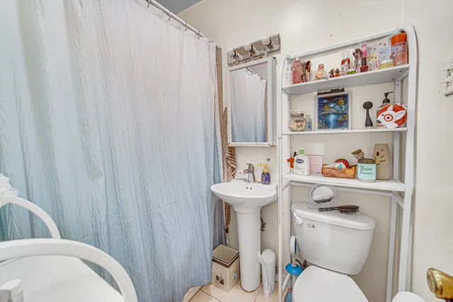 a view of a kitchen with fridge and sink